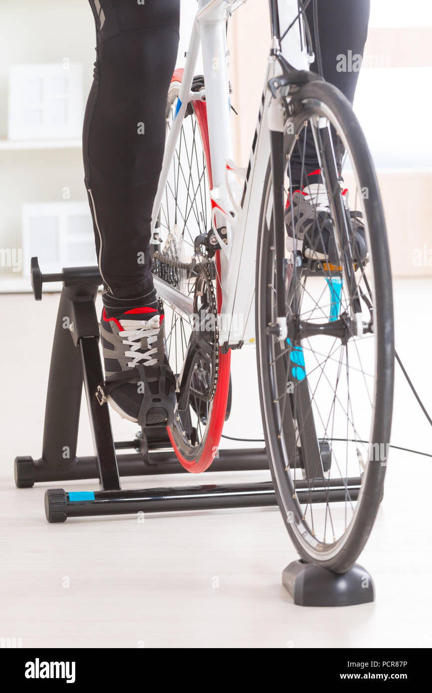 Man using cycle trainer at home Stock Photo Alamy