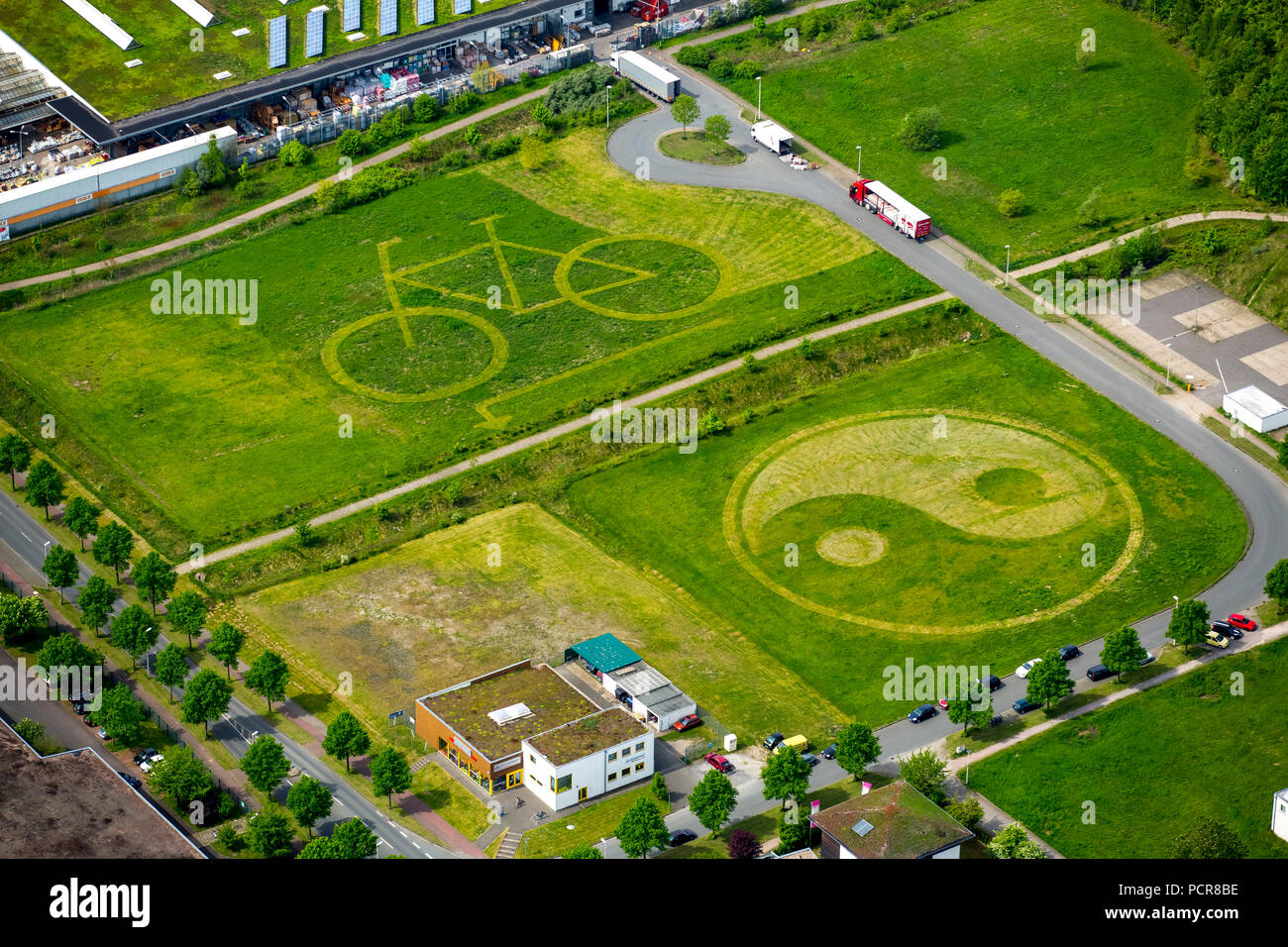 Mowing Art, Lawnmower Art, Lawn Mower Art, Bicycle and Yin and Yang characters were mowed into a meadow, Lawn Mower Art, Hamm, Ruhr area, North Rhine-Westphalia, Germany Stock Photo
