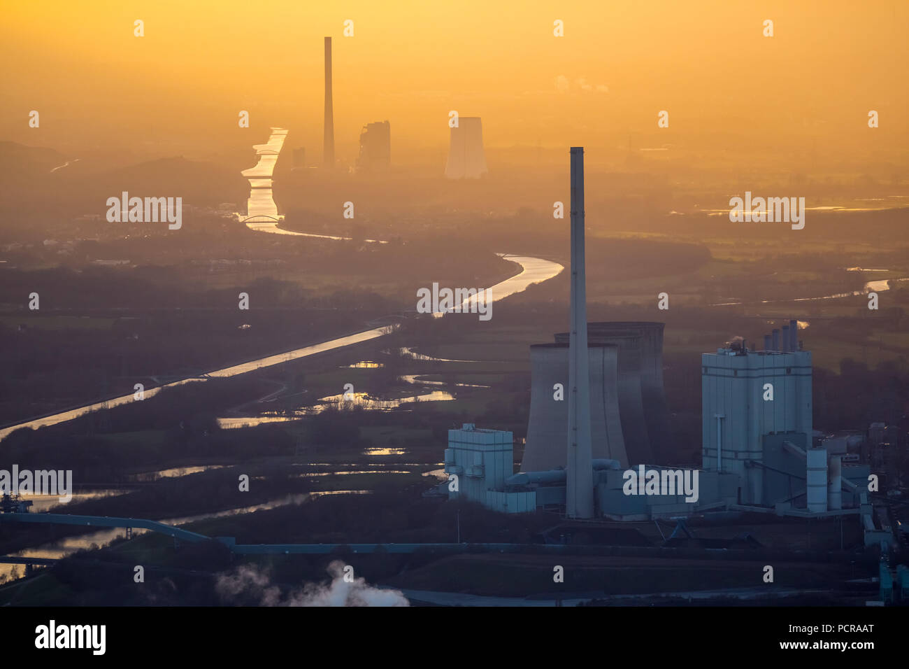 Gersteinwerk power plant, RWE power, RWE, coal power station in front with STEAG Bergkamen coal power plant behind, Datteln-Hamm-Kanal, evening sun, Golden light, industrial romanticism, industrial backdrop, sunset reflection, haze, smog, misty weather, inversion weather situation, back light, Werne, Ruhr area, North Rhine-Westphalia, Germany Stock Photo