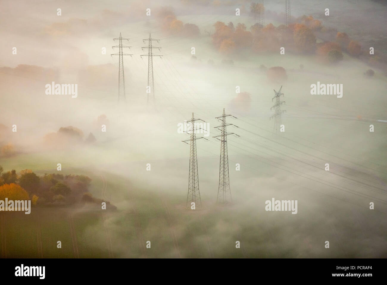 High voltage pylons in the fog in the Ruhr bend in Hattingen, energy ...