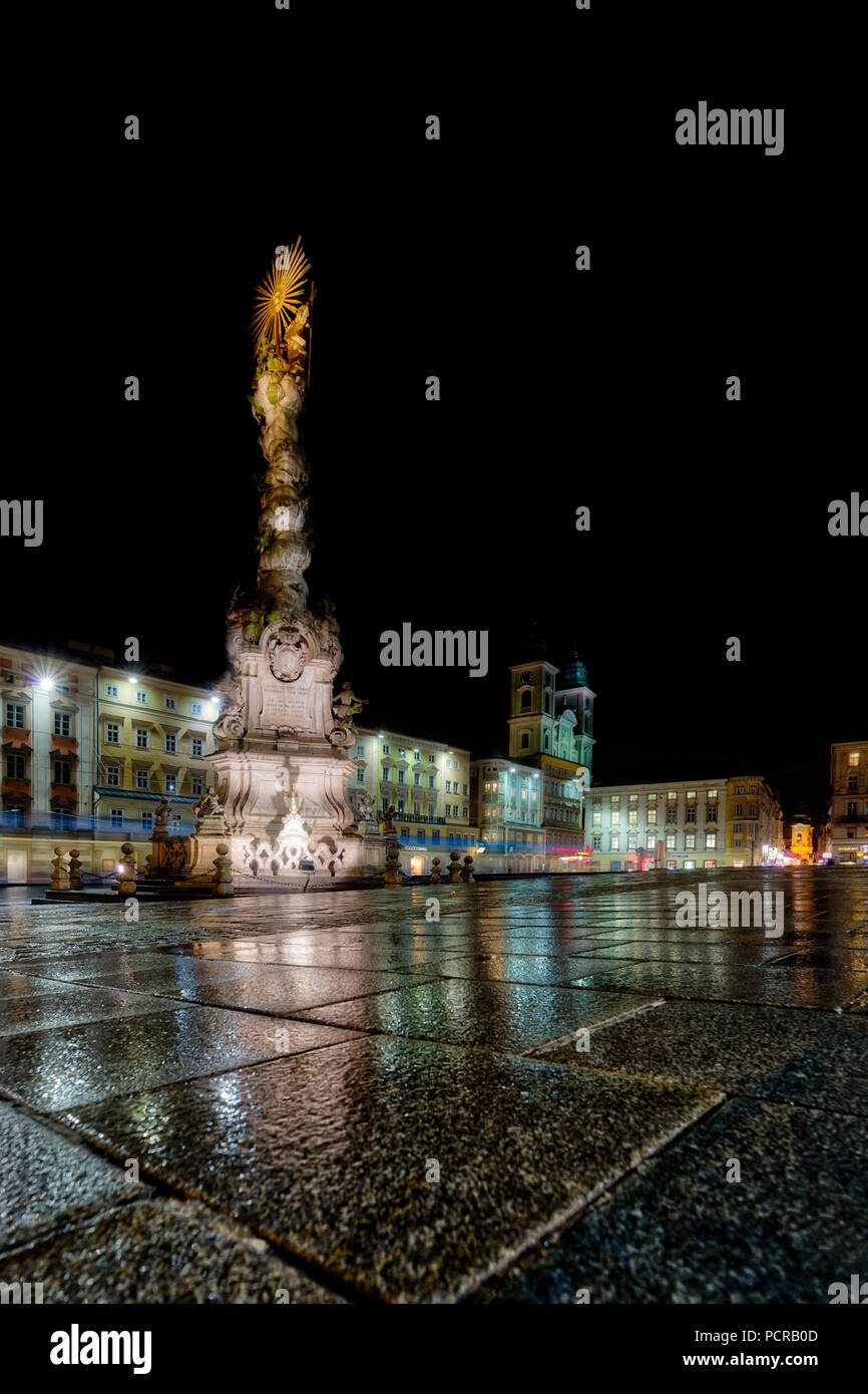 Trinity column on the Linz main square, rainy night Stock Photo