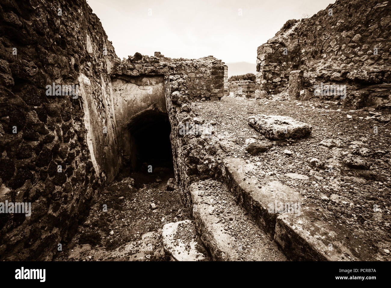 Entrance to a dark cellar room underneath the city, ruins of the ancient city of Pompeii, near Naples, Italy Stock Photo