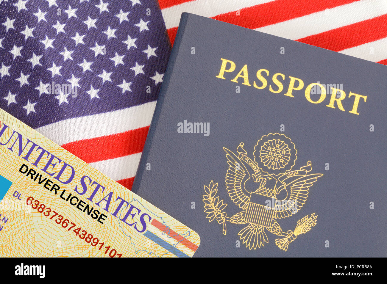 American Passport Close Up With Drivers License on Top of USA Flag. Stock Photo