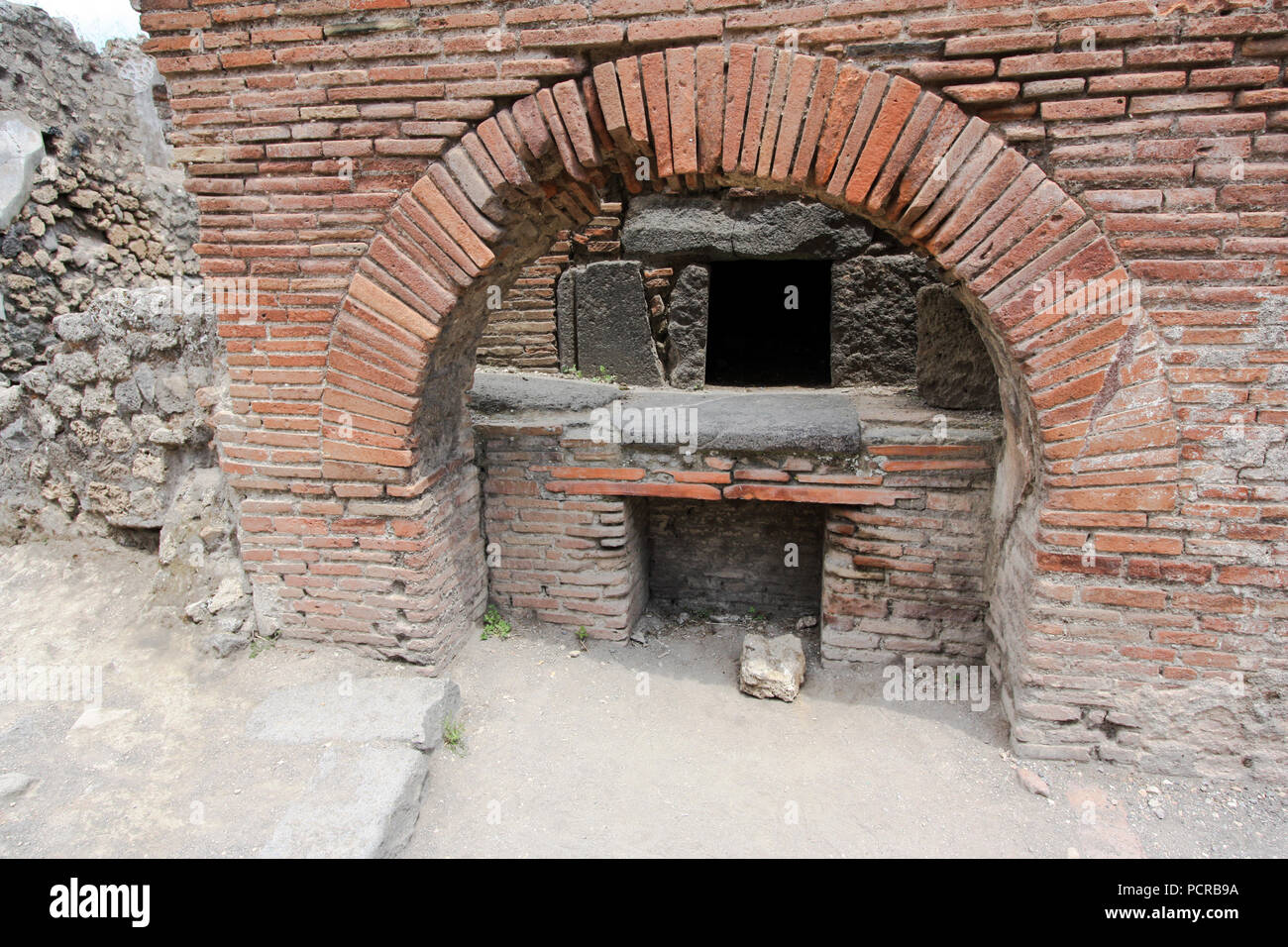 Masoned clay oven at the House of the Baker, the Casa del Forno, an ancient bakery at the ancient city of Pompeii, near Naples, Italy Stock Photo