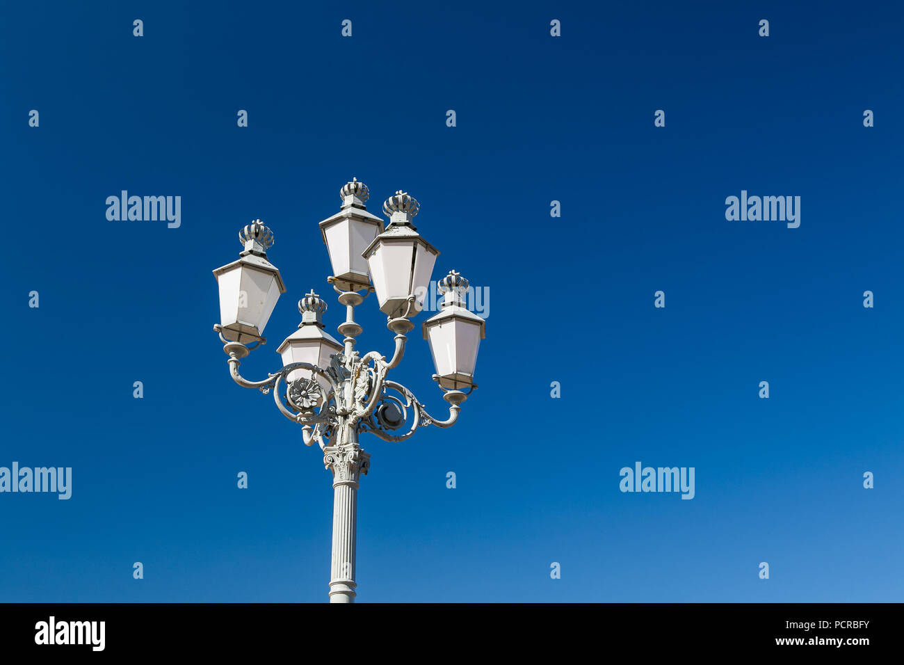 Decorative lamppost with multiple lanterns in broad day light. Stock Photo