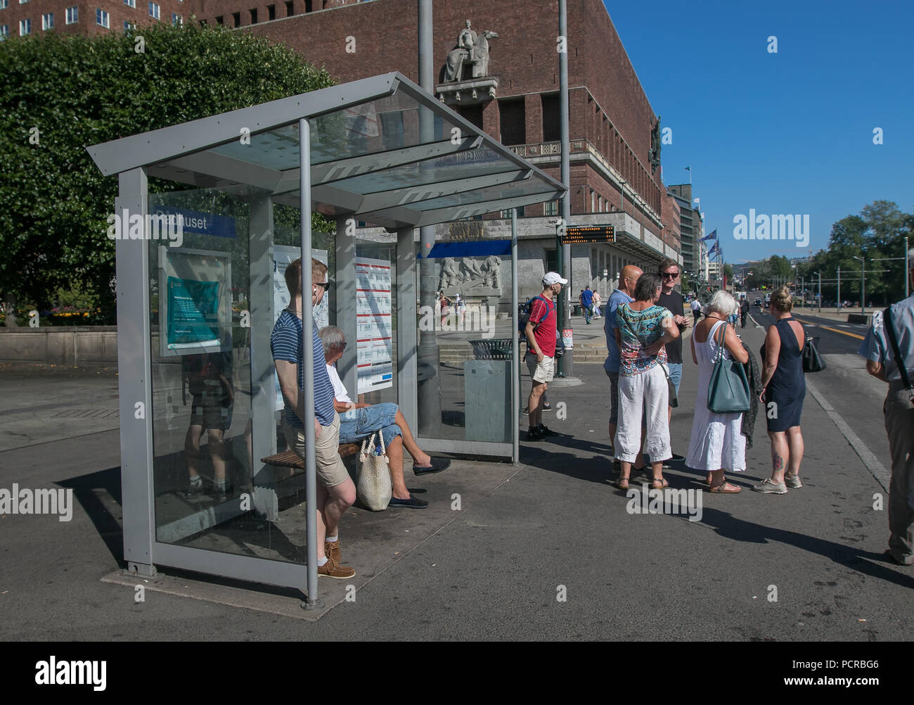 Oslo, Norway, July 21, 2018: People are waiting for a bus at a bus stop near City Hall. Stock Photo