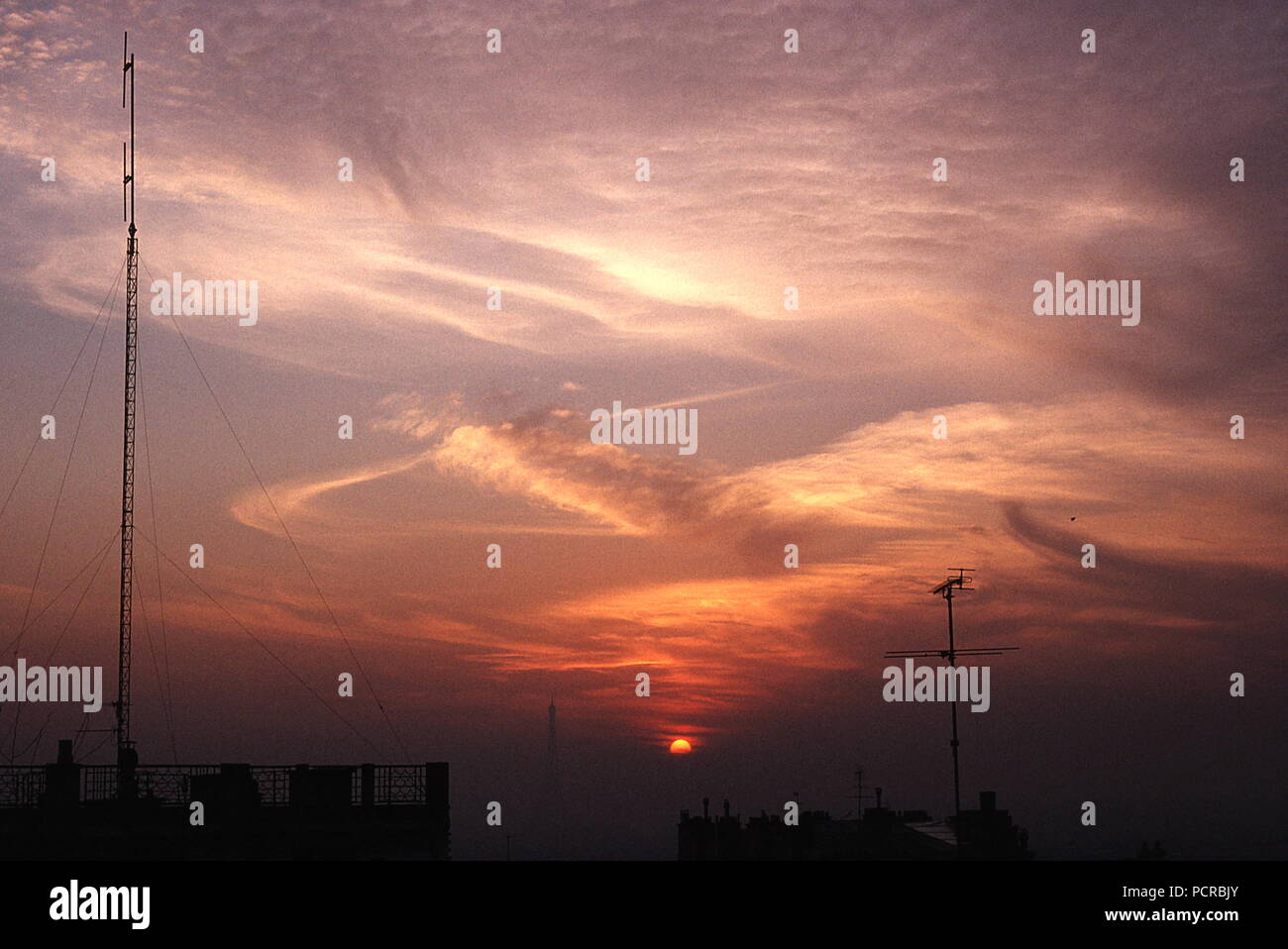 AJAXNETPHOTO. DECEMBER. PARIS, FRANCE - EIFFEL TOWER SUNSET - VIEW FROM MONT MARTRE ACROSS ROOFTOPS TOWARD EIFFEL TOWER JUST VISIBLE IN DISTANT WINTER MIST AT SUNSET.  PHOTO:JONATHAN EASTLAND/AJAX REF: 891652 Stock Photo