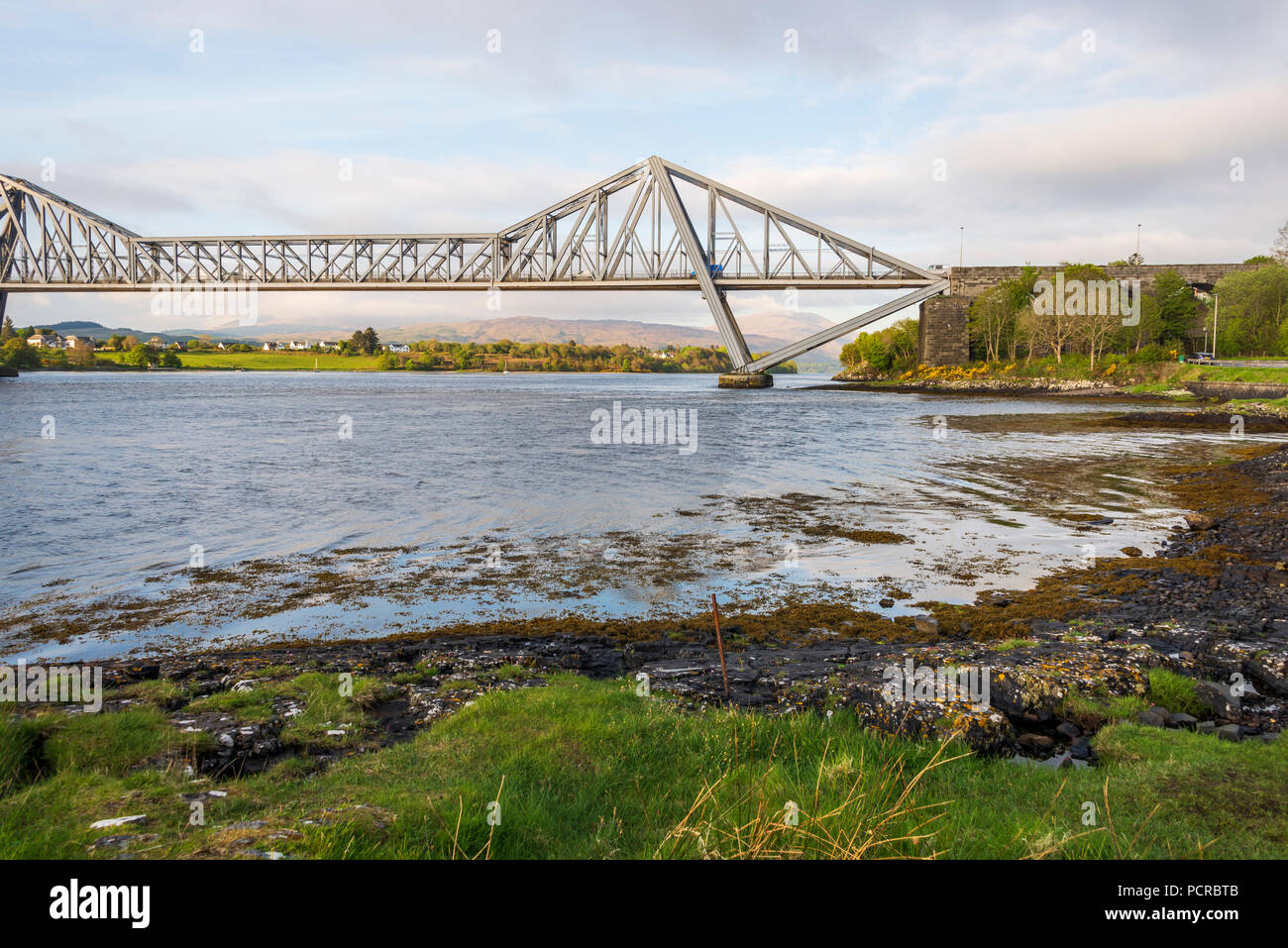 sunset over the Connel bridge and Lora waterfall Stock Photo