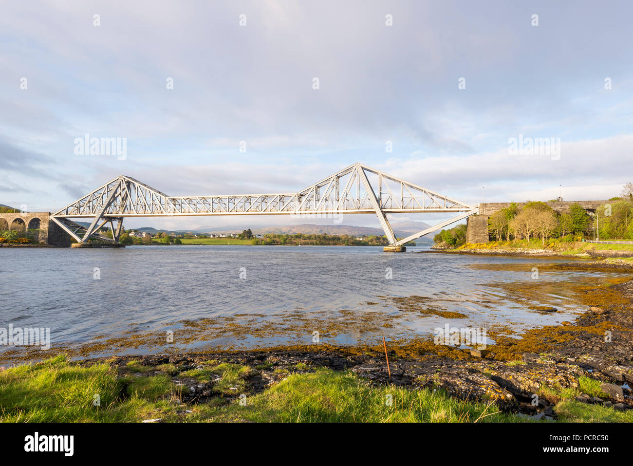sunset over the Connel bridge and Lora waterfall Stock Photo