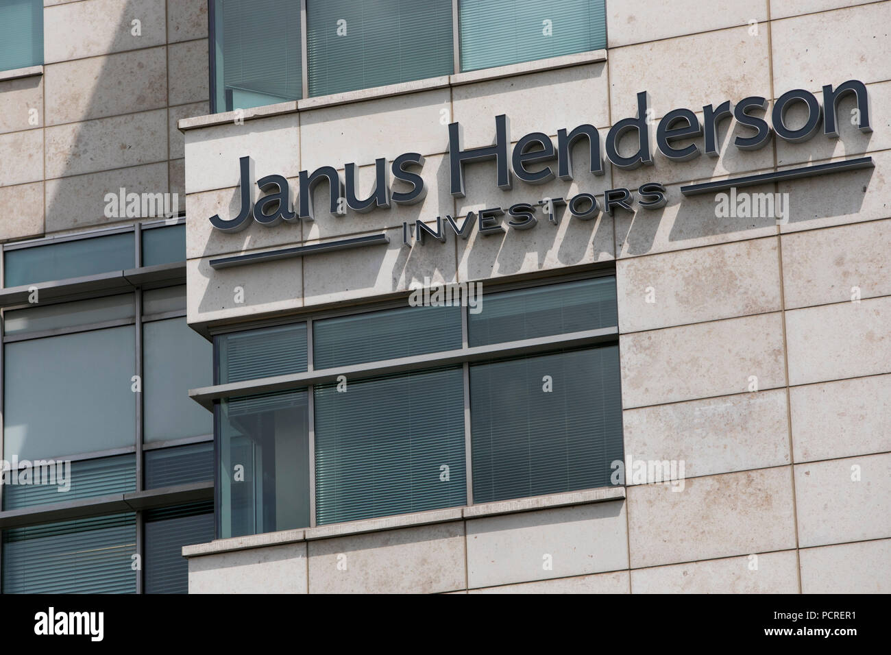A logo sign outside of a facility occupied by the Janus Henderson Group in Denver, Colorado, on