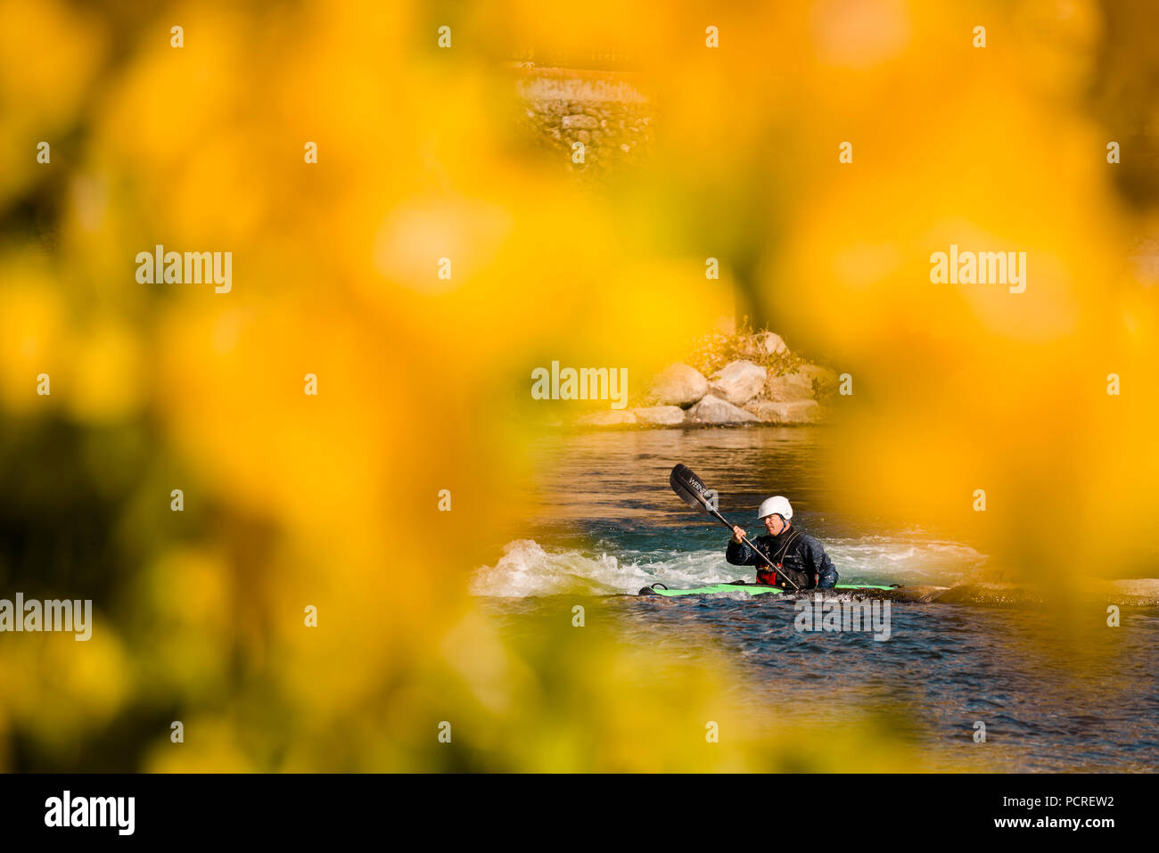 Fall colors and kayaker in Reno whitewater park in downtown Reno