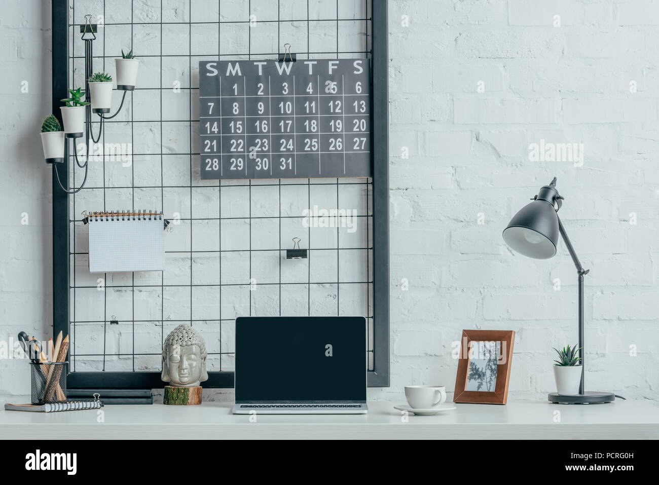 Laptop with blank screen on table in modern office Stock Photo - Alamy
