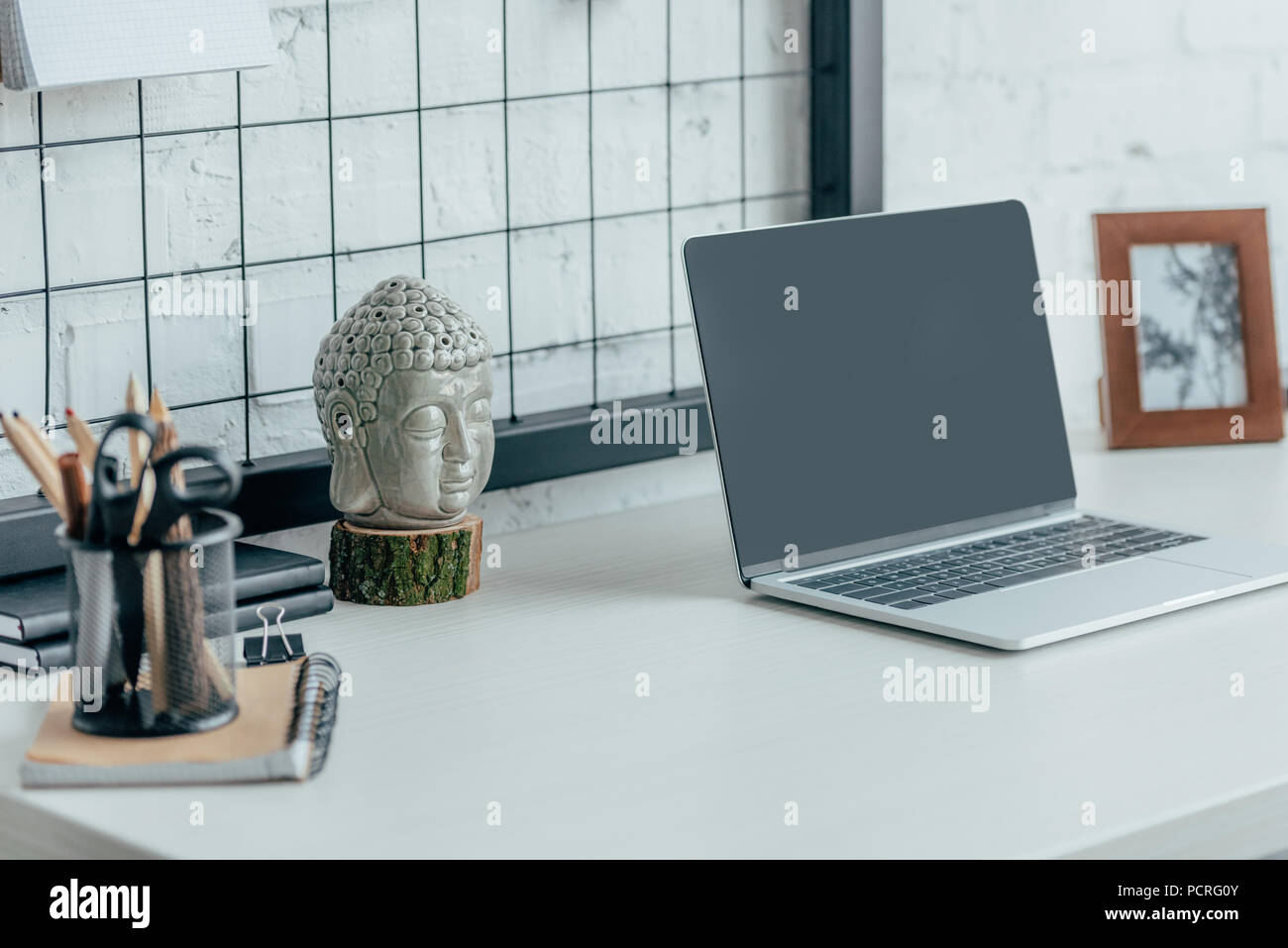 Laptop with blank screen on table in modern office Stock Photo - Alamy