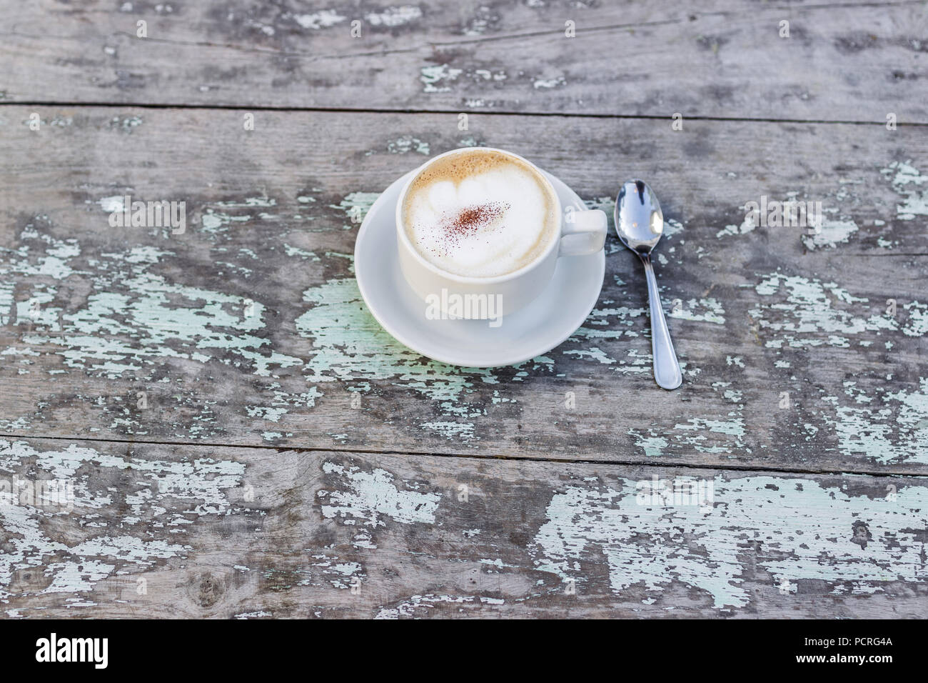 Aroma cappuchino in white cup on old whitetable Stock Photo - Alamy