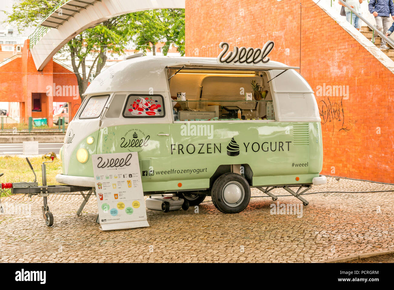 Old Volkswagen bus converted into food truck selling frozen yogurt. Lisbon Portugal. Stock Photo