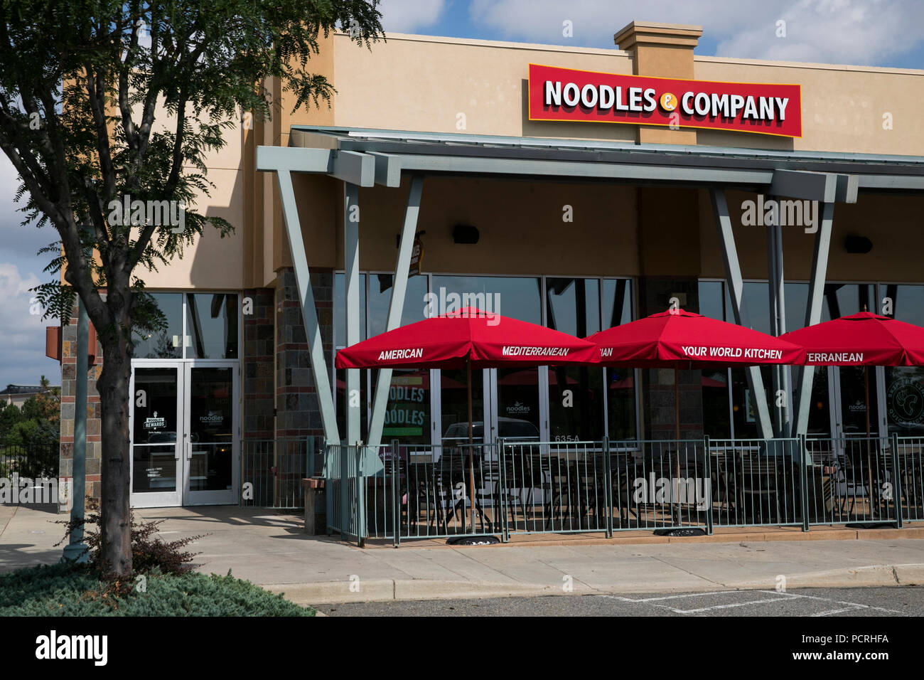 A logo sign outside of a Noodles & Company fast casual restaurant