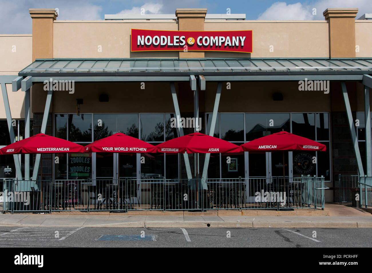 A logo sign outside of a Noodles & Company fast casual restaurant