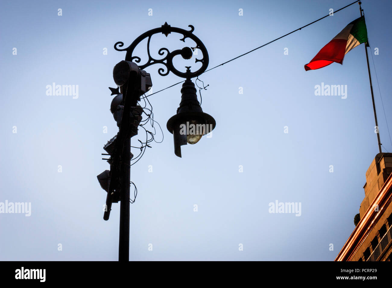 The top of the Mexico Bank waving a flag connected with a cable with a classic like Lamp Post. Stock Photo