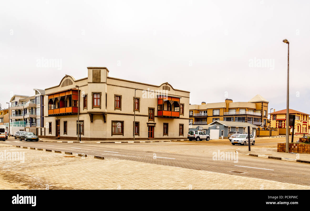 Old German colonial buildings and crossroad with some traffic, Swakopmund, Namibia Stock Photo