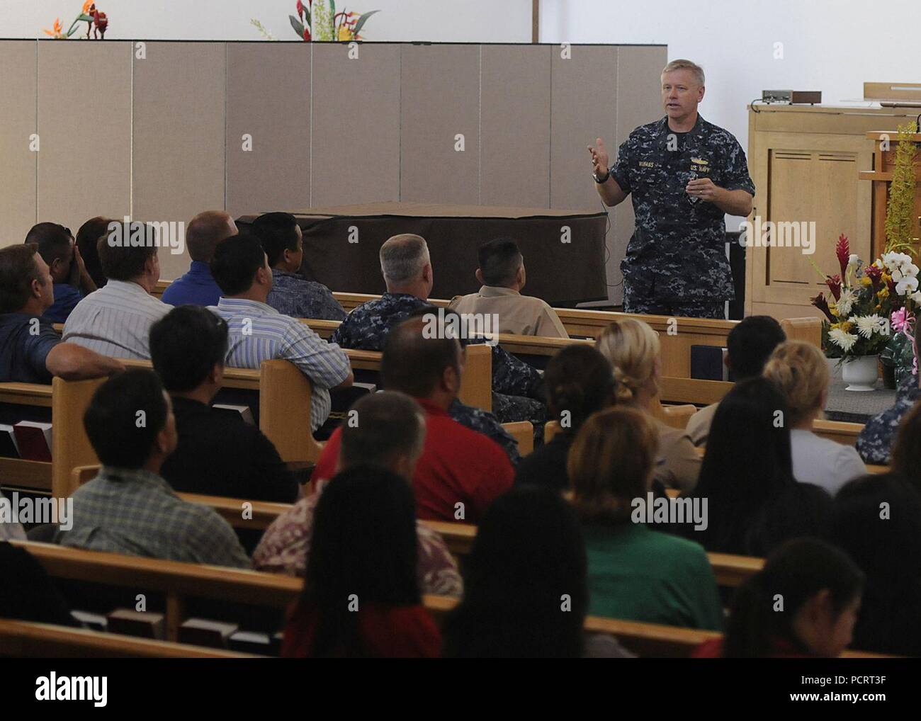 PEARL HARBOR (Aug. 15, 2013) Rear Adm. Rick Williams, commander of Navy Region Hawaii and Naval Surface Group Middle Pacific, delivers remarks on operational, family and personal readiness issues during an all-hands call at the Joint Base Pearl Harbor-Hickam Memorial Chapel. It was the first all-hands call for Williams since assuming command in July. ) Stock Photo