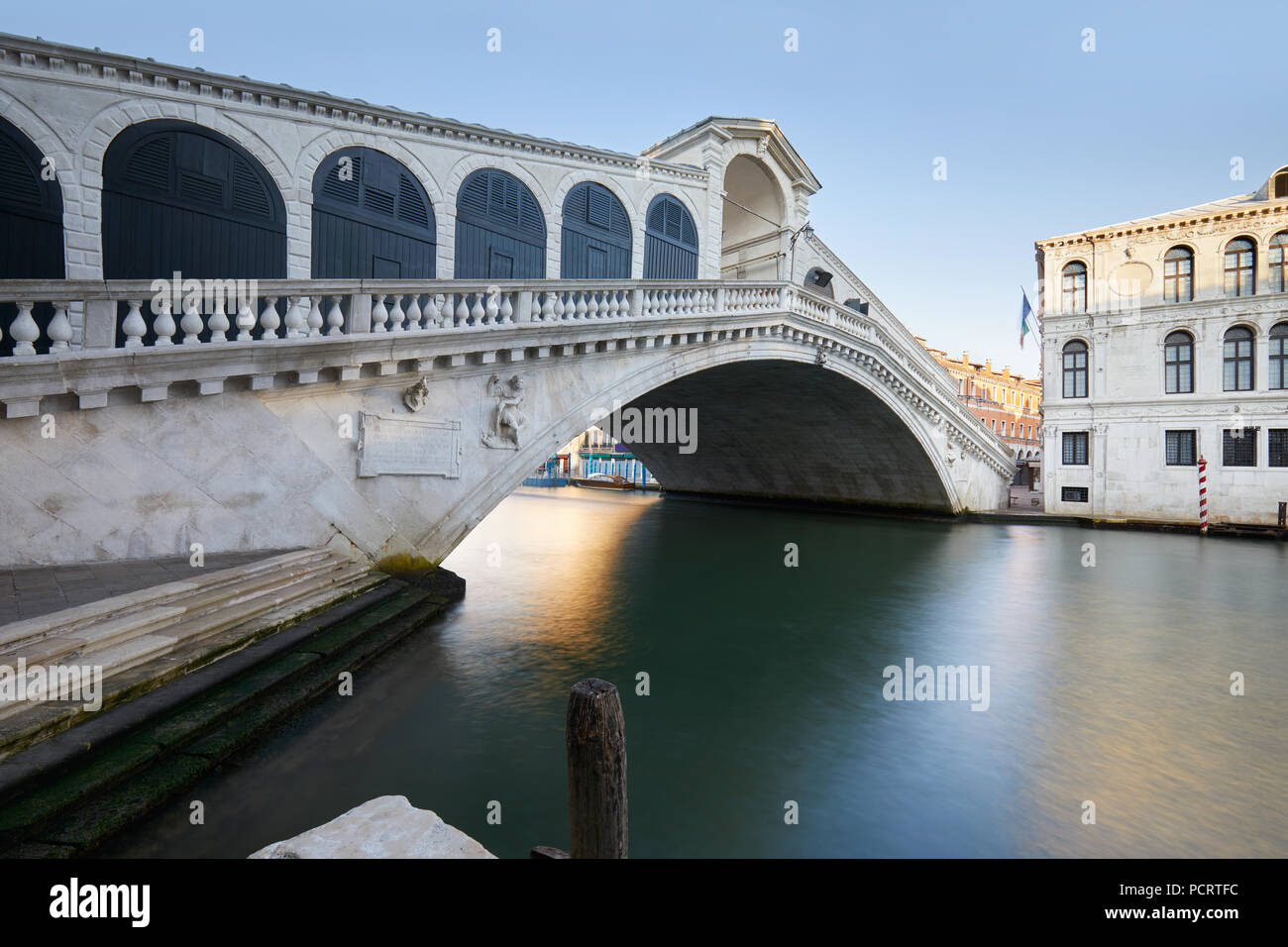 Rialto bridge and The Grand Canal in Venice, nobody in the calm morning, Italy Stock Photo