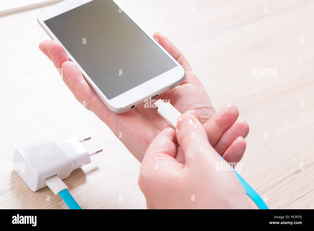 Hand connecting USB charging cable to the smart phone Stock Photo Alamy