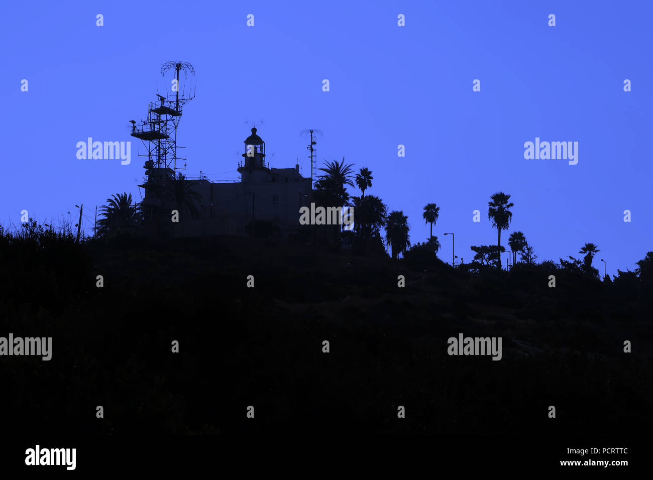 Silhouetted view of the former Carmelites Stella Maris Lighthouse used by the Israeli Navy since 1948 in front of  the Stella Maris Monastery on mount Carmel in the city of Haifa northern Israel Stock Photo