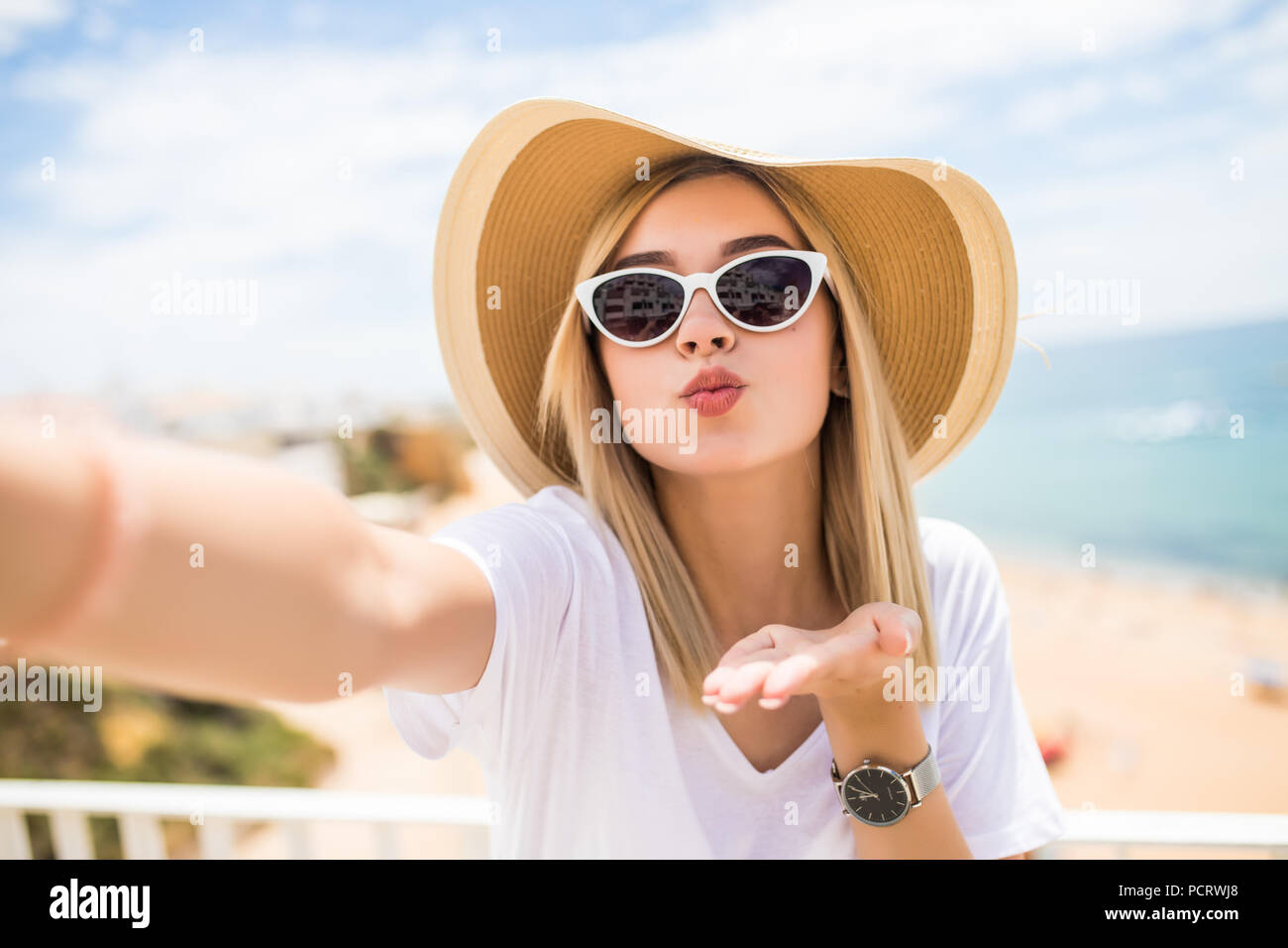 Cheerful Young Woman In Hat And Sunglasses Taking Selfie With Mobile