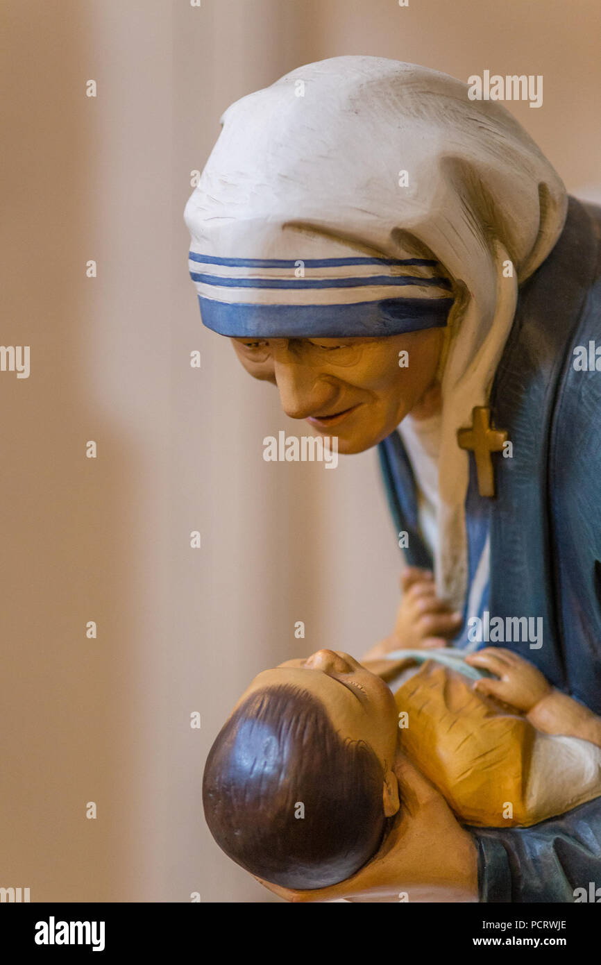 RAVENNA, ITALY - AUGUST 2, 2018: Statue of Mother Teresa of Calcutta holding a child inside  Church of Saint Mary of Suffrage in Ravenna Stock Photo