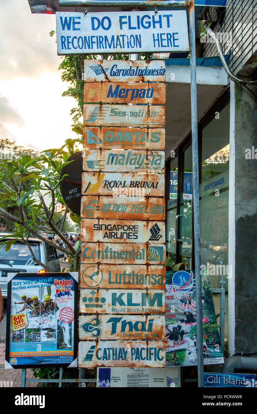 Road sign of a travel agency, flight confirmation, flight confirmation for the airlines Garuda Indonesia, Merpati, Sempati Air, Qantas, Malaysian Airways, Royal Brunai, Air New Zealand, Singapore Airlines, Continental, Lufthansa, KLM Royal, Royal Airways, Thai, Cathay Pacific, Ubud, Bali , Indonesia, Asia Stock Photo