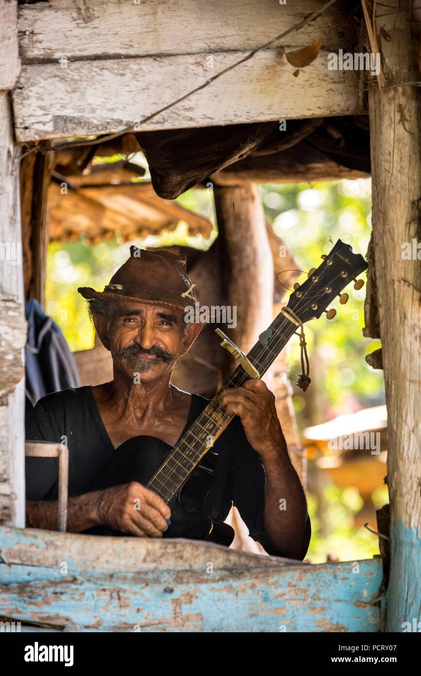 Sugarcane farmer in the Valle de los Ingenios plays guitar for the tourists, Trinidad, Cuba, Sancti Spíritus, Cuba Stock Photo