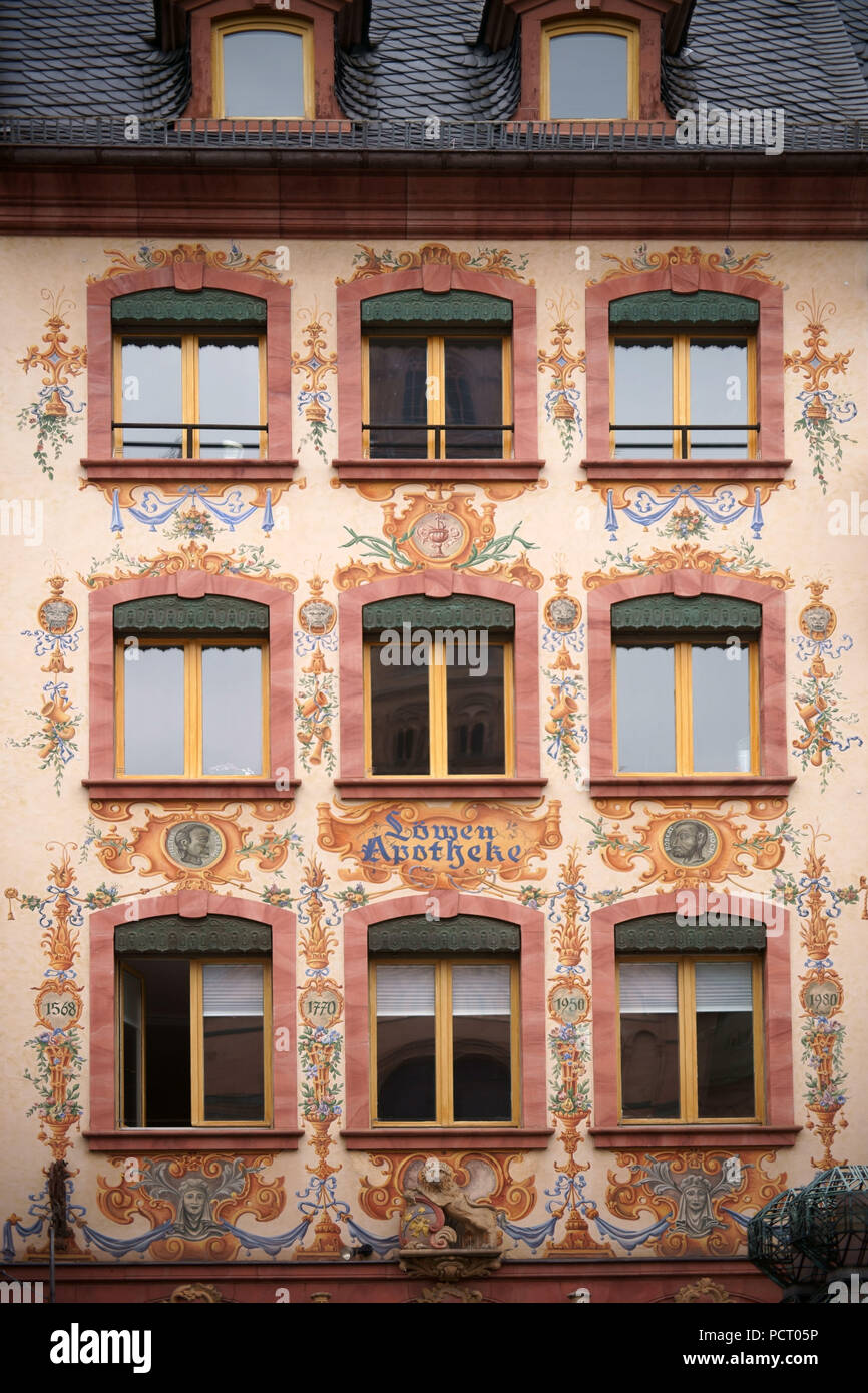 The landmarked historic building of the 'Löwen Apotheke' (pharmacy) at the cathedral in Mainz, painted with flora and famous heads Stock Photo