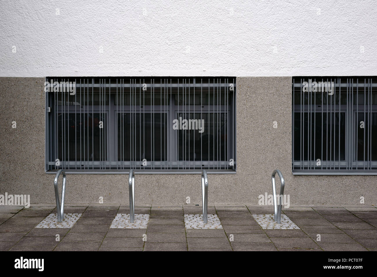 Modern and in series arranged bicycle racks made of stainless steel in ...