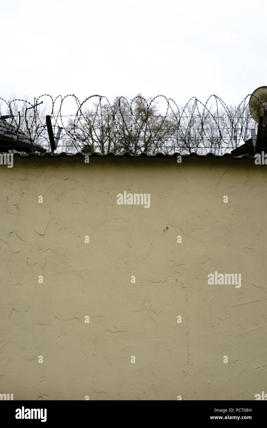 Barbed wire on top wall hi-res stock photography and images - Alamy