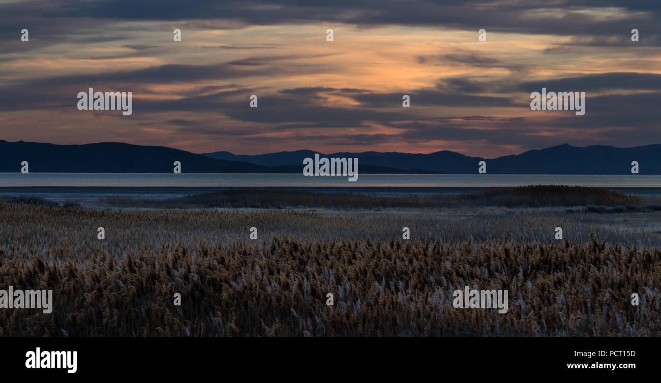 Beautiful sunset on Antelope Island in the Great Salt Lake looking into the distant mountains across the lake. Stock Photo