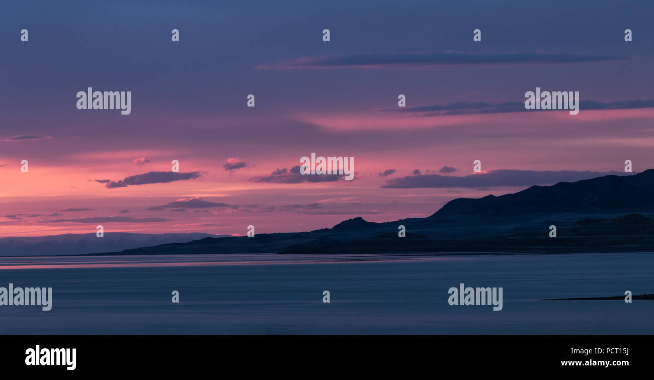 Beautiful sunset on Antelope Island in the Great Salt Lake looking into the distant mountains across the lake. Stock Photo