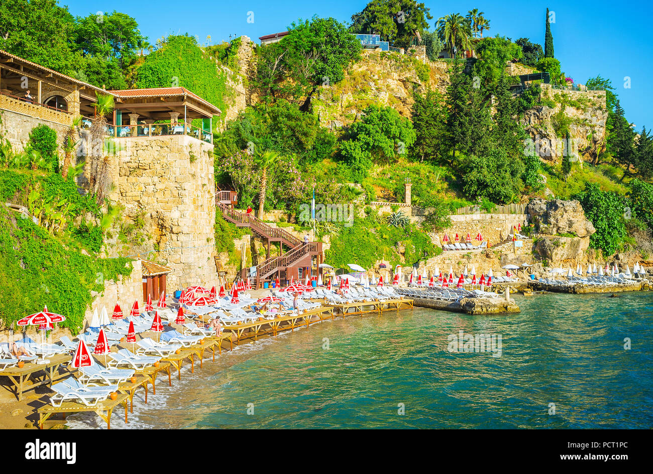 ANTALYA, TURKEY - MAY 11, 2017: Mermerli beach is the popular place in old town, neighboring with marina, public garden and numerous coastal restauran Stock Photo