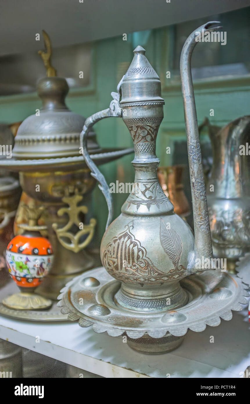 The old Arabic dallah coffee pot with fine Islamic pattern in antique store of Antalya, Turkey. Stock Photo