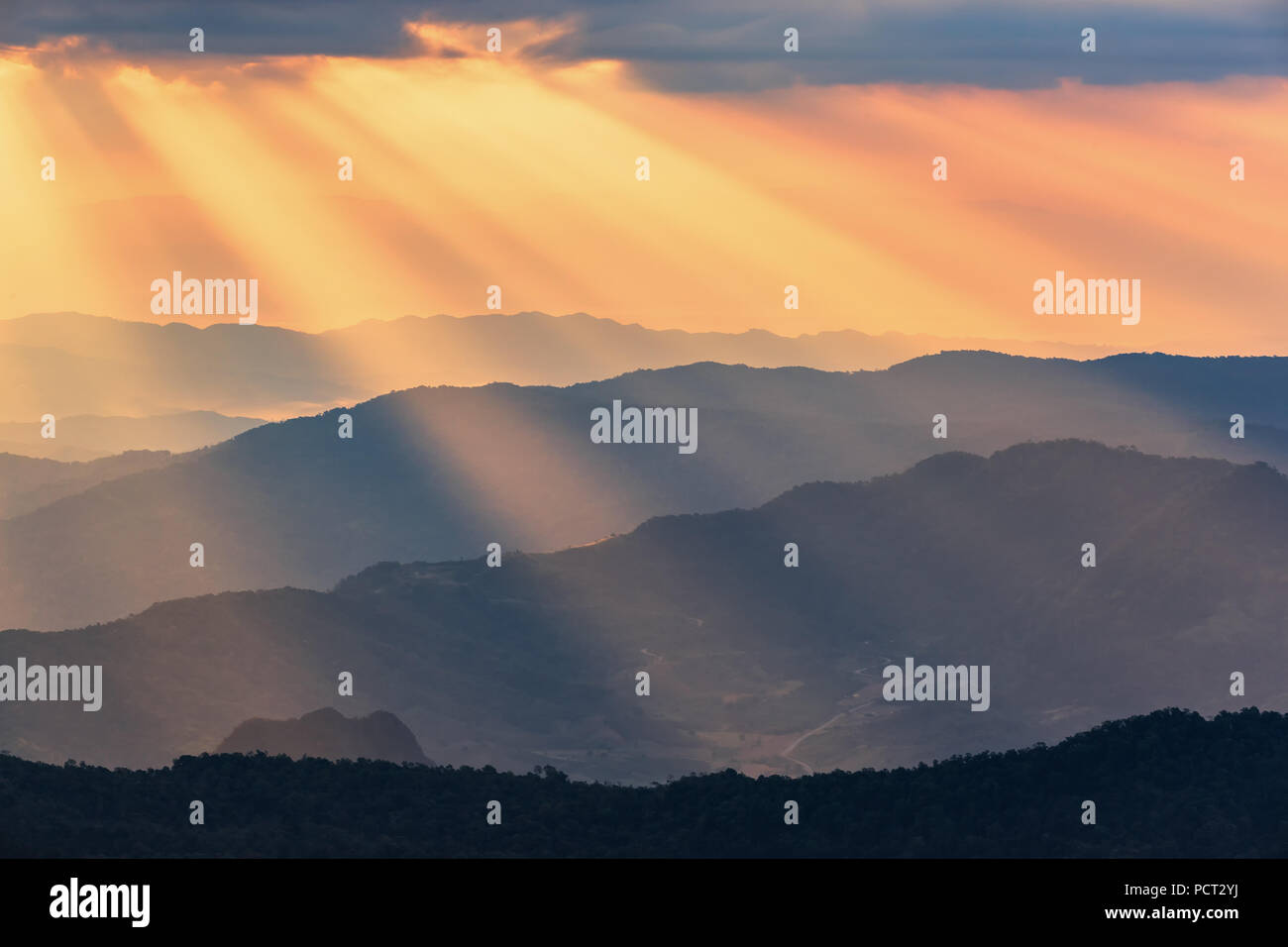 Rays of light shining through dark clouds . dramatic sky with cloud Stock Photo