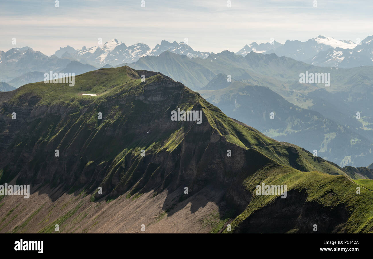 beautiful mountain scenery in the swiss alps with cross on the mountain peak Stock Photo