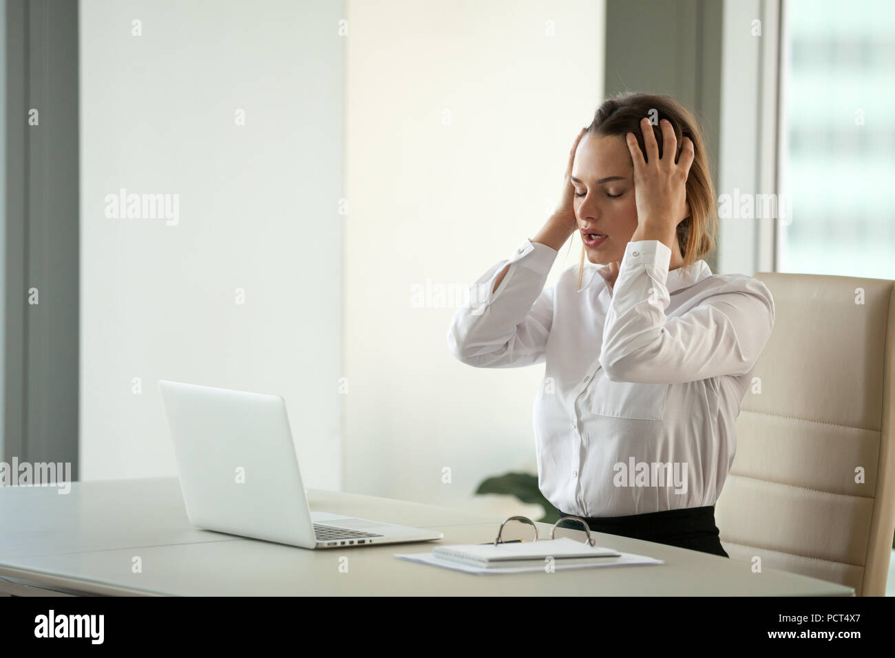Stressed businesswoman feeling despair suffering from overwork Stock Photo