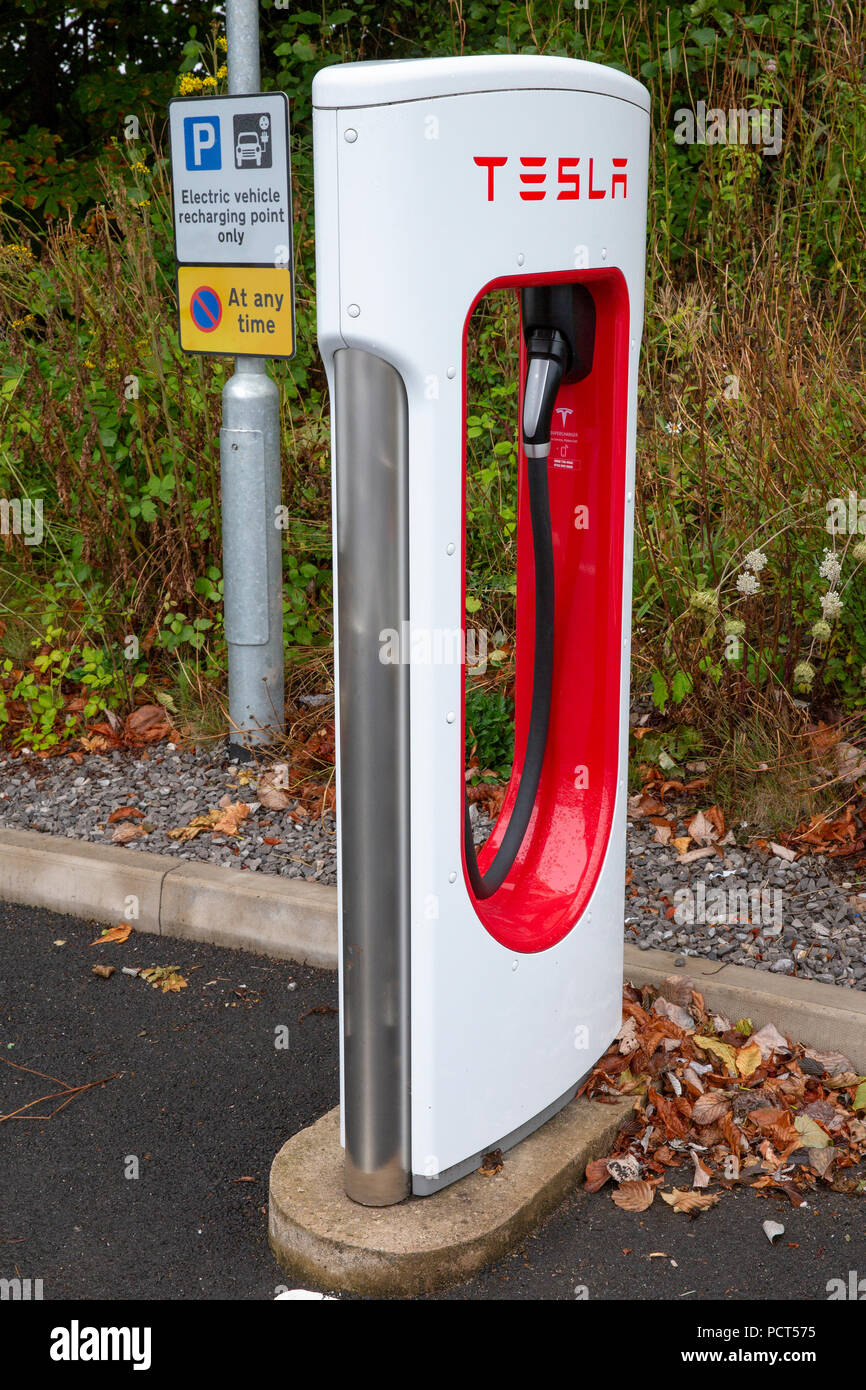 SARN, UNITED KINGDOM - AUGUST 2, 2018 : A  Tesla Supercharger and parking sign at the Sarn Park motorway services off the M4 near Bridgend in Wales. Stock Photo