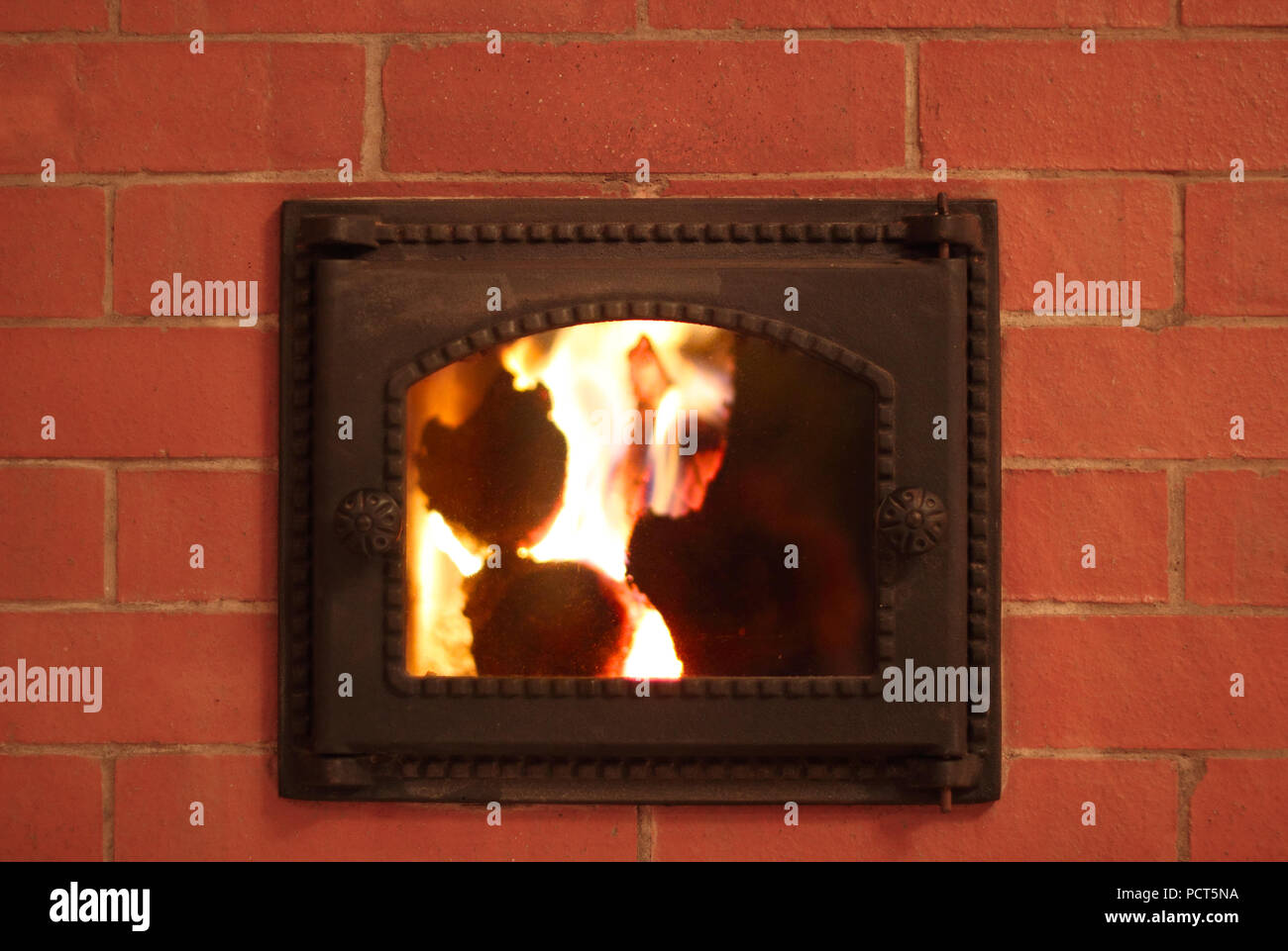 Cast iron furnace door in the brick oven photo Stock Photo