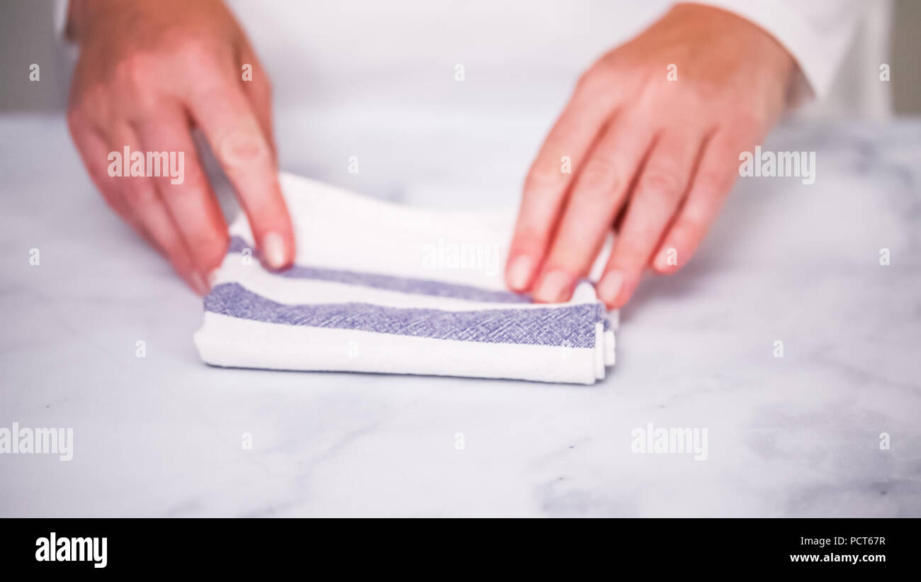 Folding Blue And White Patterned Paper Towels On Marble Surface