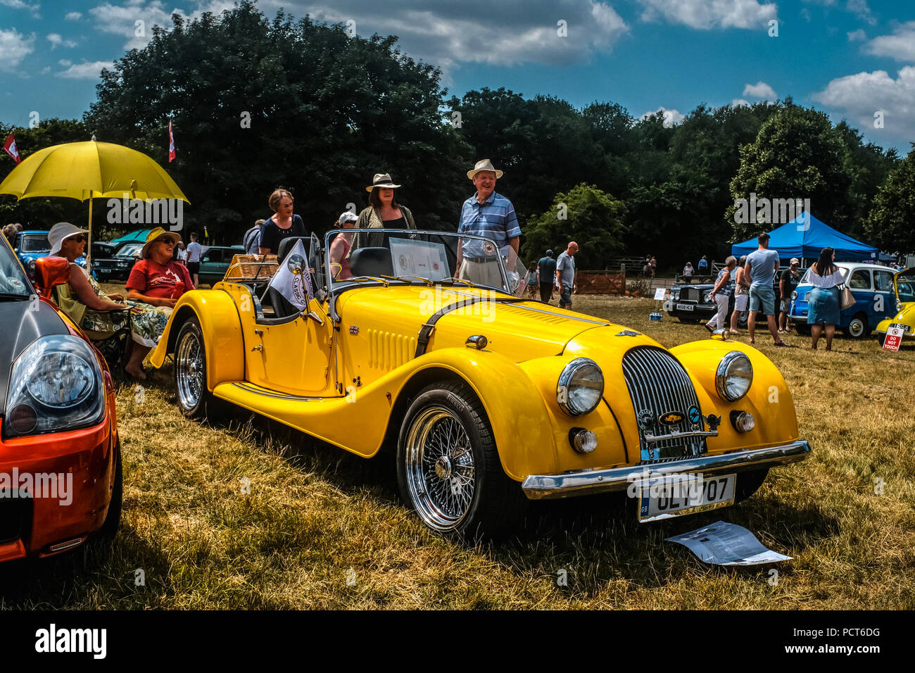 Family day out at a classic car show held at the historic manor house