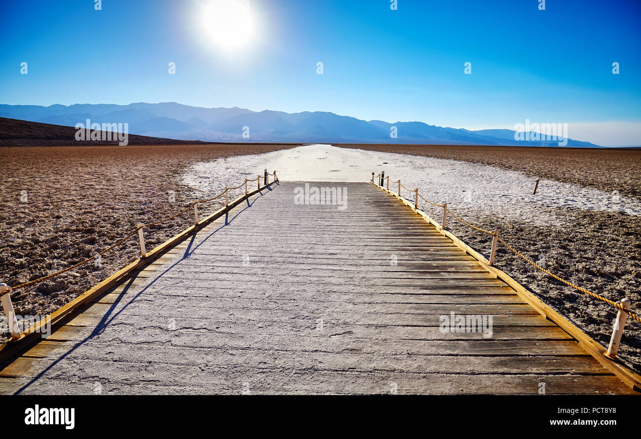 Wooden viewing platform at the Badwater Basin, the second-lowest point in the Western Hemisphere, at sunset, Death Valley National Park, California. Stock Photo