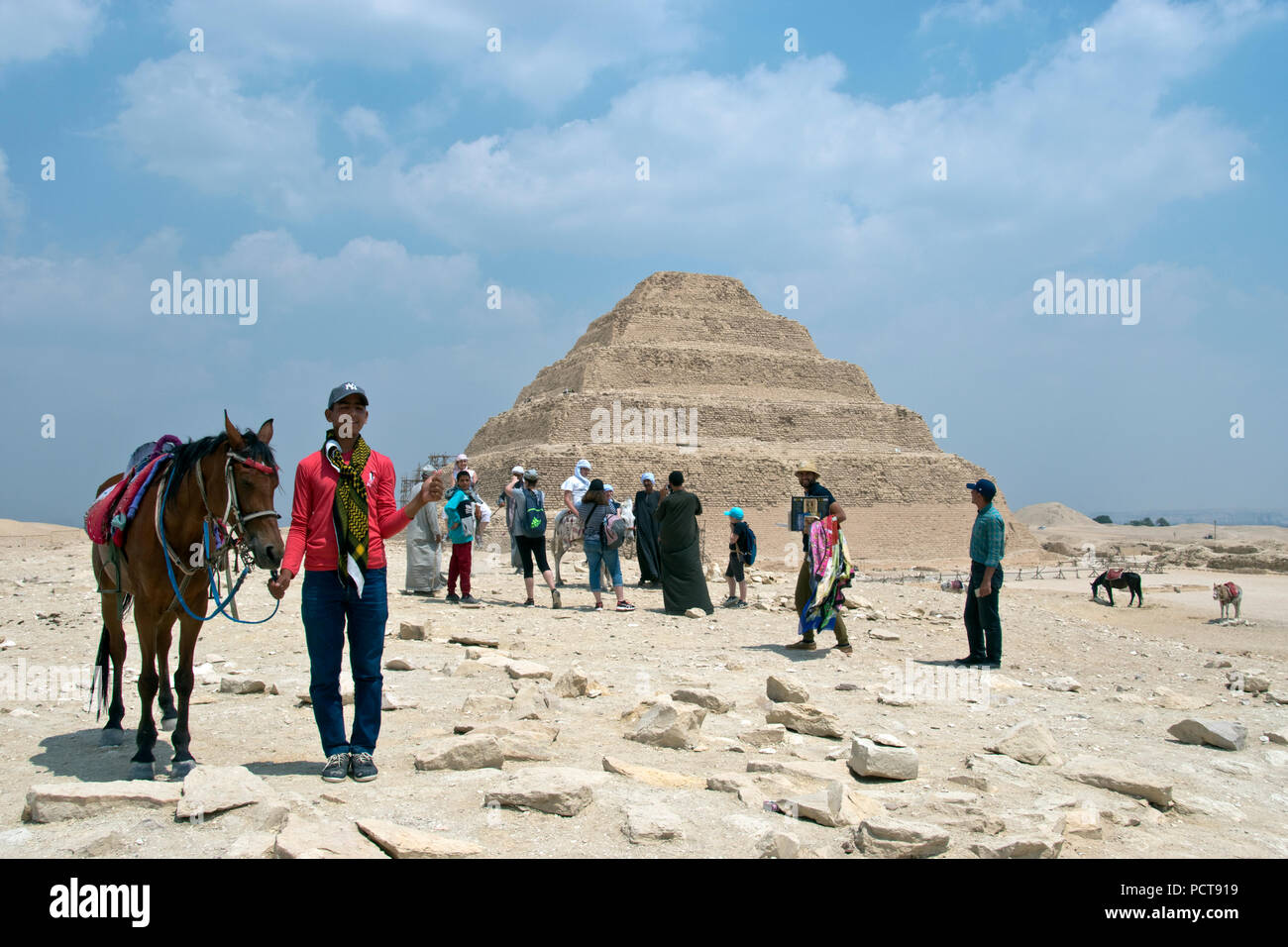 A boy offers a horse for tourists to ride at the Pyramid of Djoser at