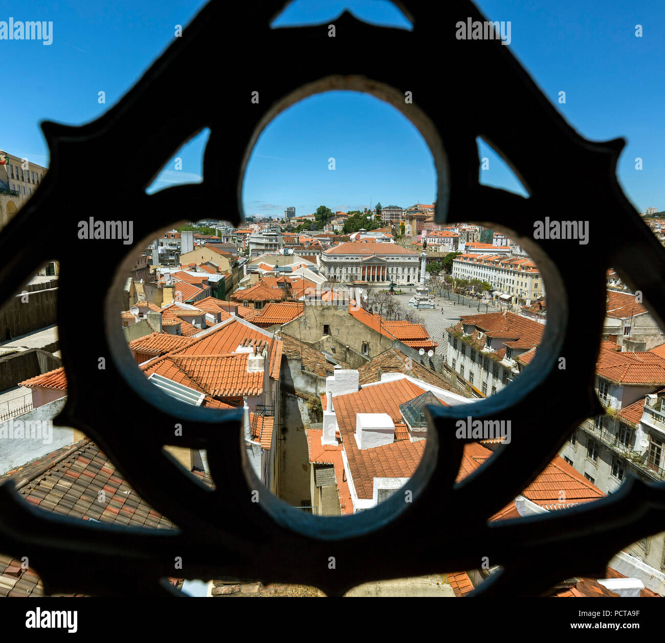 View through wrought iron grille from the most famous elevator in Portugal Elevador do Município or Elevador da Biblioteca and Elevador de S. Julião on the old town of Portugal with the red roofs, Lisbon, District of Lisbon, Portugal, Europe Stock Photo