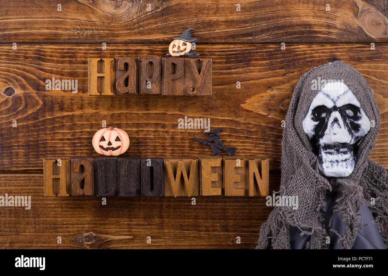 Happy Halloween sign with halloween decorations on a wood background Stock Photo