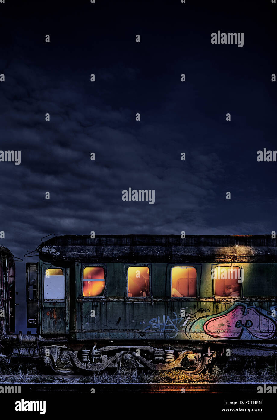 Wagon, desolate, graffiti, night, illuminated from inside, interior devastated, photography, [M], retouched, RailArt Stock Photo